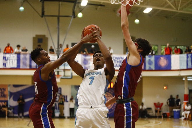 Five-star prospect Isaiah Todd, center, drives to the basket during Nike's Peach Jam.