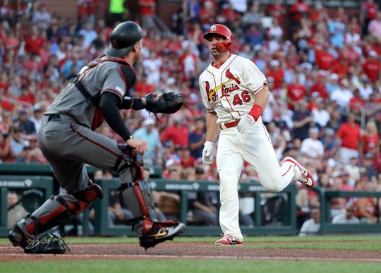 St. Louis Cardinals' Paul Goldschmidt (46) scores past Arizona Diamondbacks catcher Carson Kelly during the first inning of a baseball game Saturday, July 13, 2019, in St. Louis.