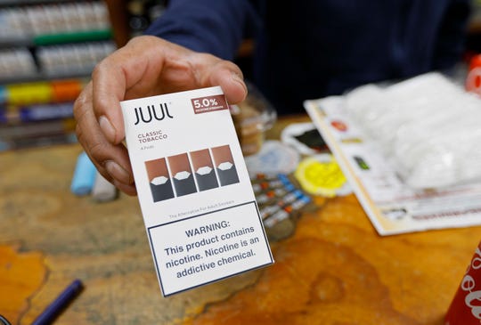 On Monday, June 17, 2019, photo of the file, a cashier displays a pack of Juul capsules flavored with tobacco in a San Francisco store.