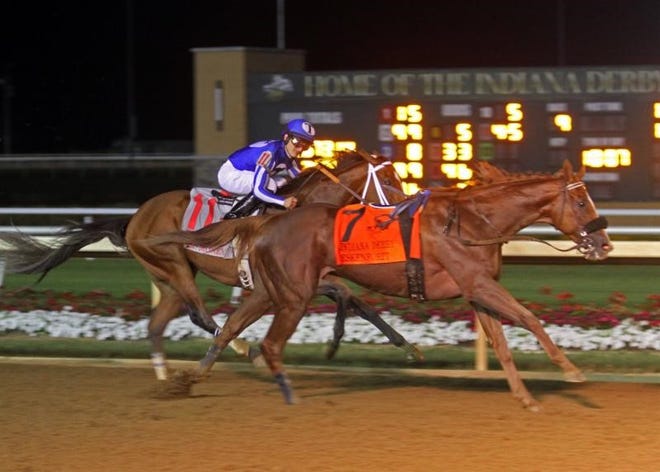 Gabriel Saez aboard Mr. Money, the official winner of Saturday night's Indiana Derby, looks over at the loose horse Eskenforit at the wire of the $500,000 Grade 3 stakes at Indiana Grand.