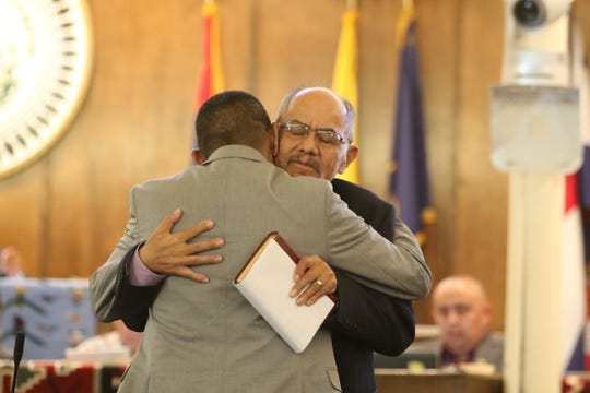 Delegate Nelson BeGaye, right, receives a hug from Delegate Pernell Halona during the Navajo Nation Council summer session on July 15 in Window Rock, Ariz. BeGaye resigned from the council, citing a health condition, on July 15.