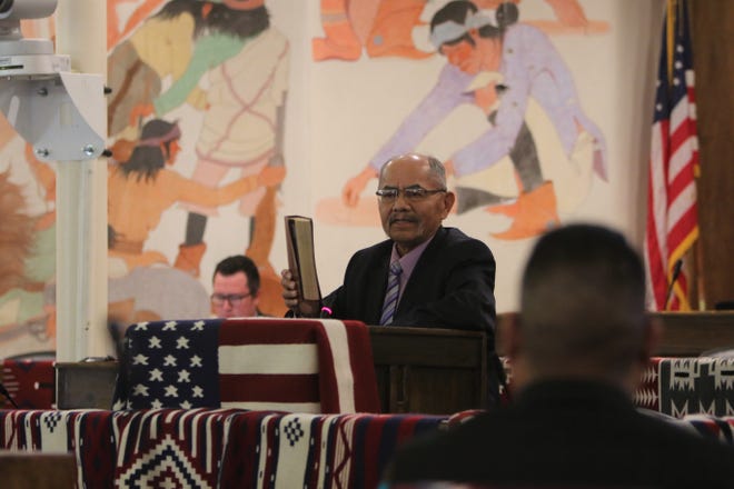 Delegate Nelson BeGaye shows his Bible while talking about his resignation from the Navajo Nation Council during the summer session on July 15 in Window Rock, Ariz.