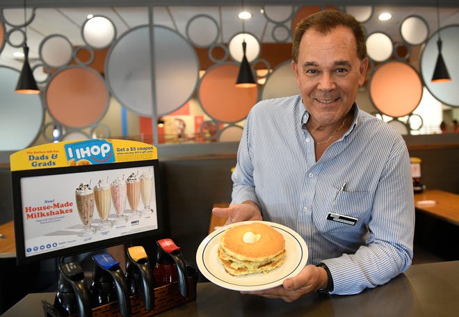 Ken Fitzpatrick, manager at the IHOP in Vineland, holds a plate of pancakes on Monday, July 15, 2019.