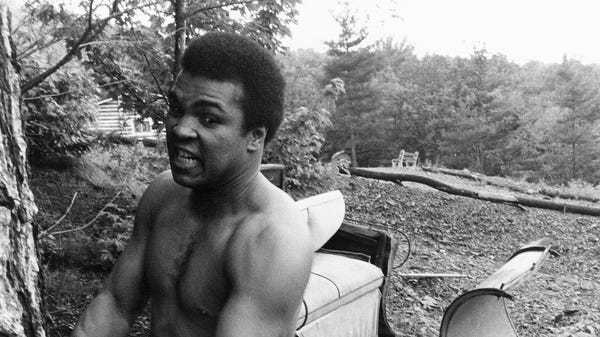 Muhammad Ali is pictured chopping wood 1974.