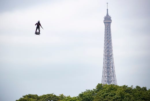 Professional pilot Franky Zapata demonstrates a flight on a 'flyboard', which the French army is considering using for military purposes, during the annual Bastille Day military parade on the Champs Elysees avenue in Paris, France, July 14, 2019.