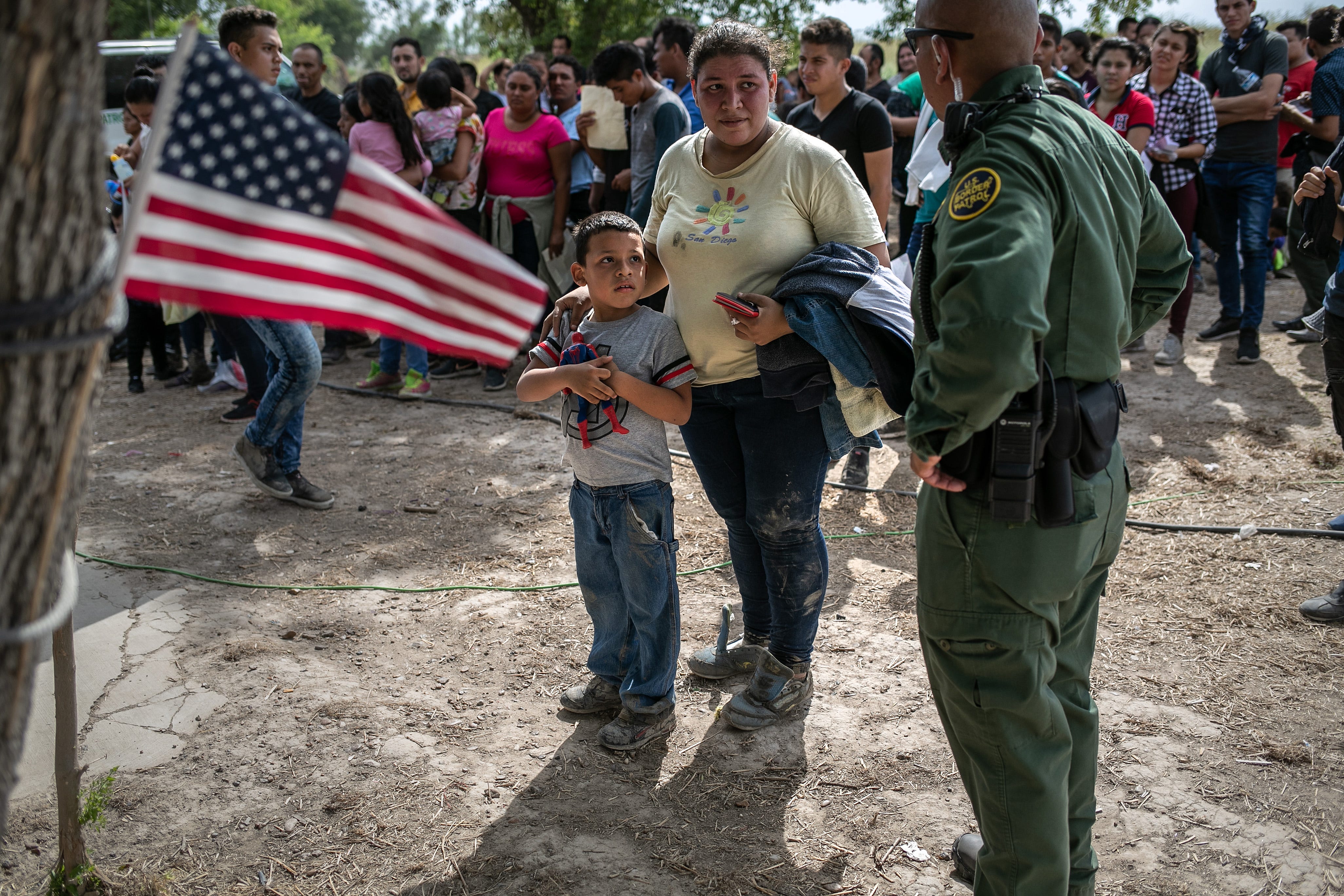 A U.S. Border Patrol agent speaks to immigrants after taking them into custody on July 02, 2019, in Los Ebanos, Texas. Hundreds of immigrants, most from Central America, turned themselves in to border agents after rafting across the Rio Grande from Mexico to seek asylum in the United States.