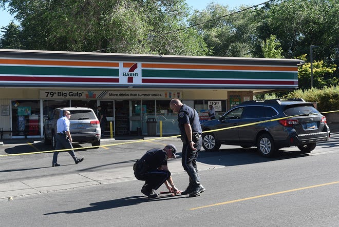 Police investigate the scene of an officer-involved shooting at a 7-Eleven store on Mt. Rose Street in Reno on July 15, 2019.