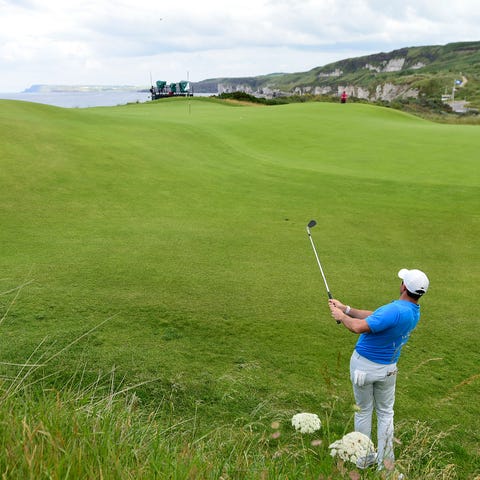 Rory McIlroy chips  on the 5th green during a...
