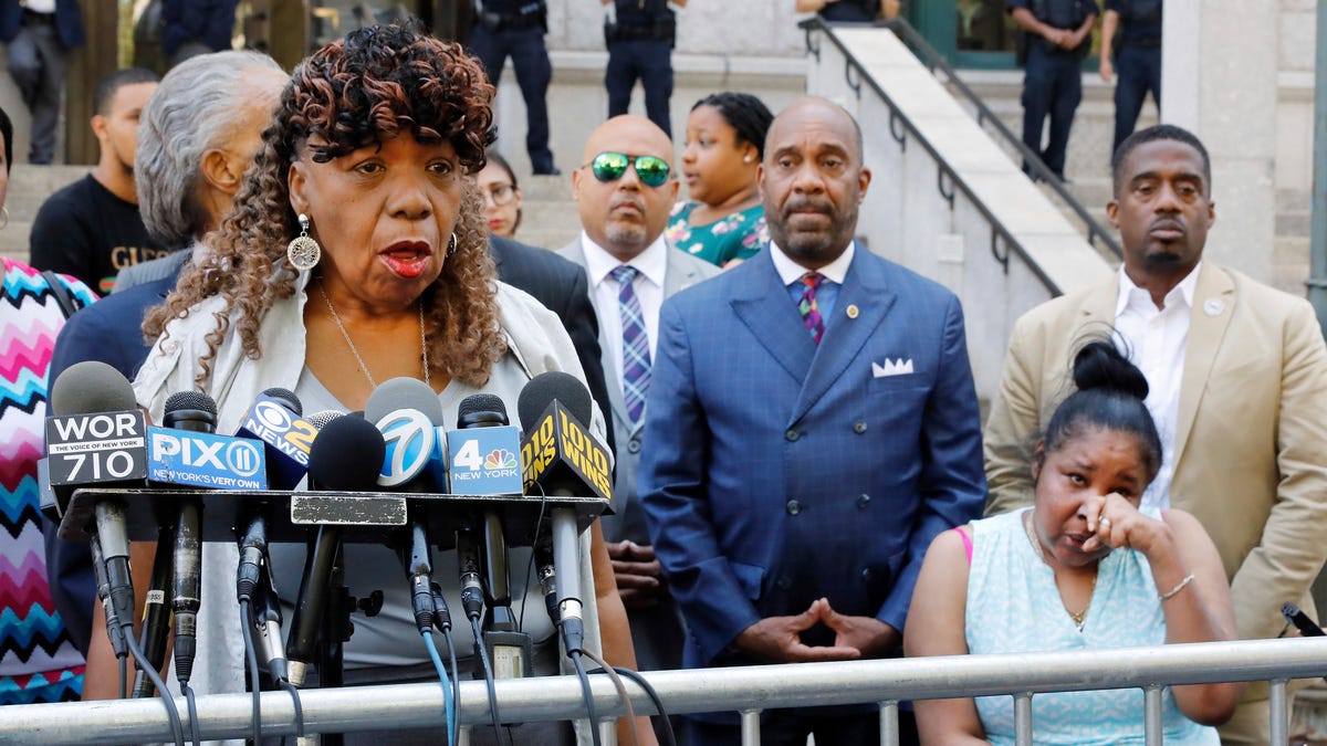 Gwen Carr, mother of chokehold victim Eric Garner, left, speaks outside the U.S. Attorney's office as Garner's widow Esaw Snipes listens at right on July 16, 2019. Federal prosecutors won't bring civil rights charges against New York City police officer Daniel Pantaleo, in the 2014 chokehold death of Garner, a decision made by Attorney General William Barr and announced one day before the five-year anniversary of his death, officials   said.