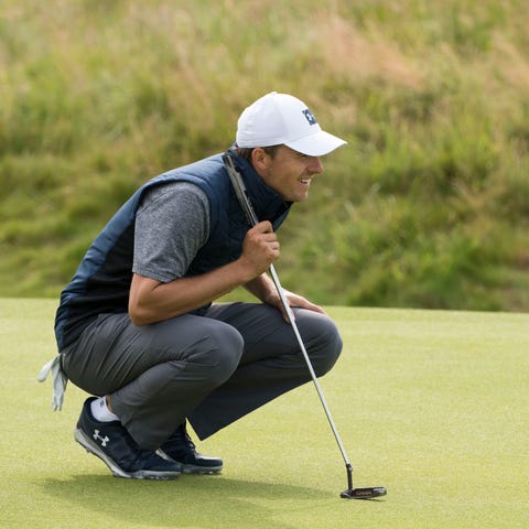 Jordan Spieth lines up a putt on the 17th during...