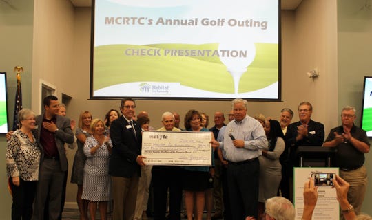 Members of the Martin County Realtors of the Treasure Coast award Habitat for Humanity of Martin County with $34,000. The money was raised at the Realtors annual golf tournament at Mariner Sands Country Club in Stuart.