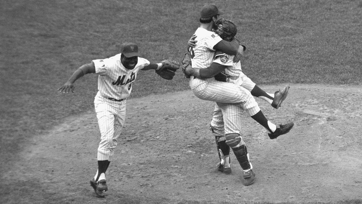 In this Oct. 16, 1969, file photo, New York Mets catcher Jerry Grote embraces pitcher Jerry Koosman as the Mets defeated the Baltimore Orioles in Game 5 to win the franchise's first World Series. At left is teammate Ed Charles.
