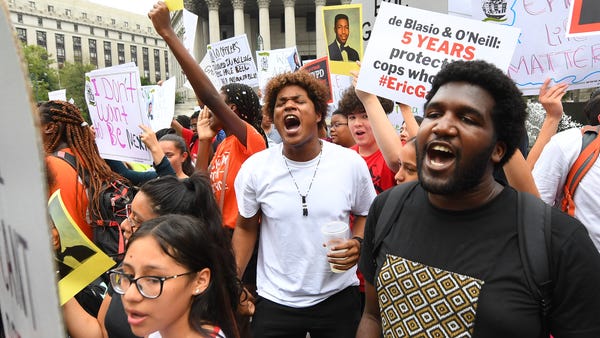 People participate in a protest to mark the...