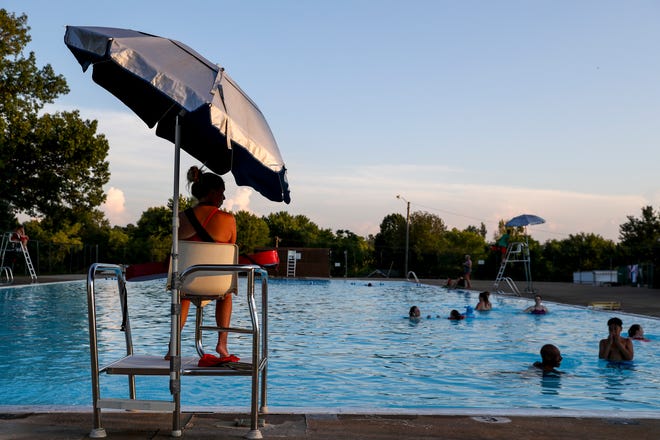 A lifeguard watches over residents while visitors play in the pool at Bel-Aire swimming pool in Clarksville, Tenn., on Wednesday, July 17, 2019. 