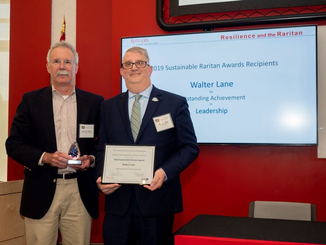 Somerset County Planning Director Walter C. Lane (right), accepts a Sustainable Raritan River Award from Bill Kibler, director of policy for the Raritan Headwaters Association and a member of the awards committee.