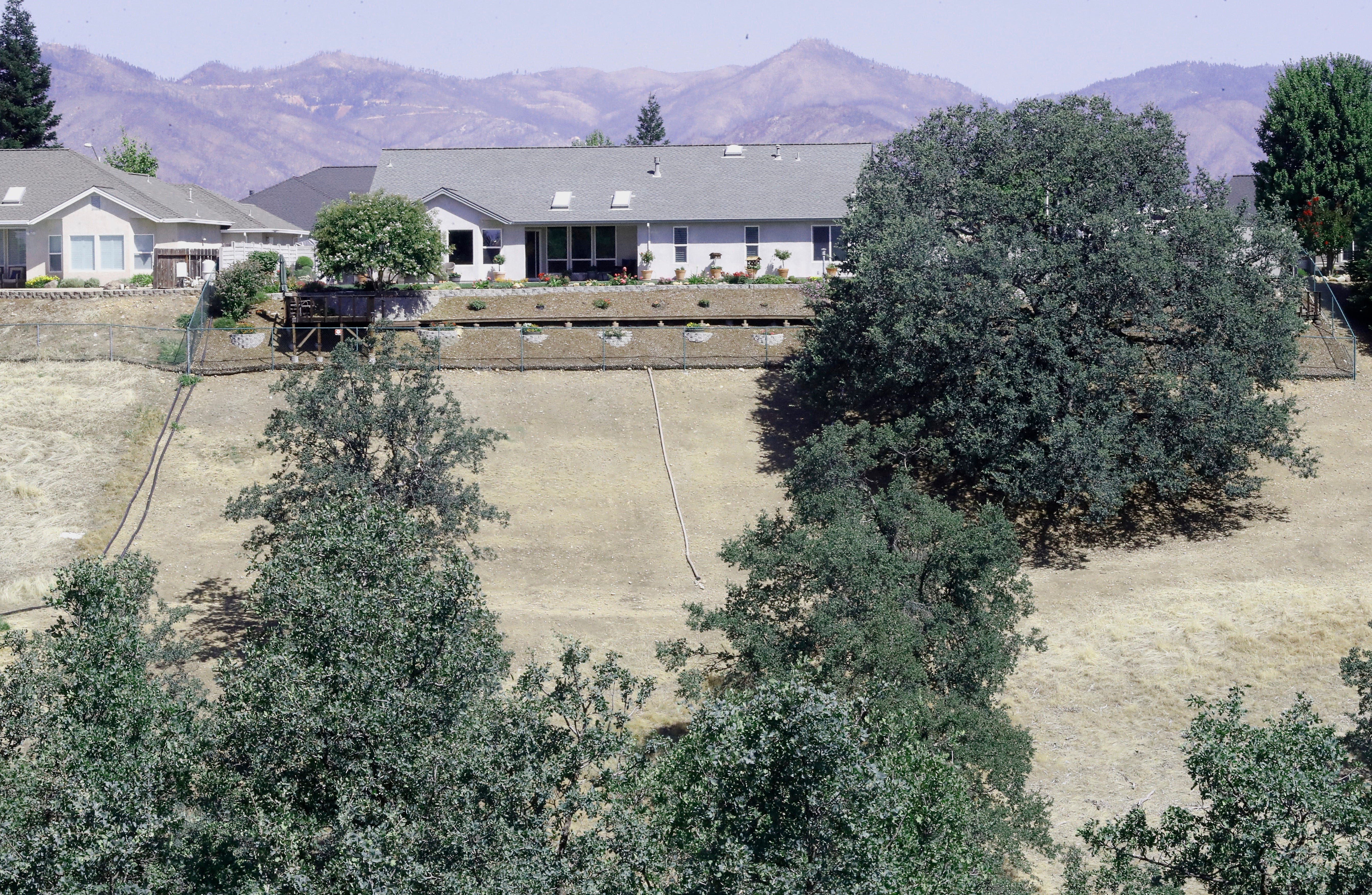 Hillside grass in the backyard of a home on Winter Green Court in Redding  has been cut to lower the fire risk.