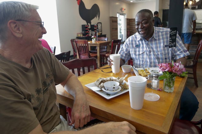 Steve Burgess, a retired attorney, and Seth Ablordeppeuy, a FAMU professor, who have been friends for at least 25 years, meet for lunch at Earley's Kitchen Thursday, July 18, 2019. 