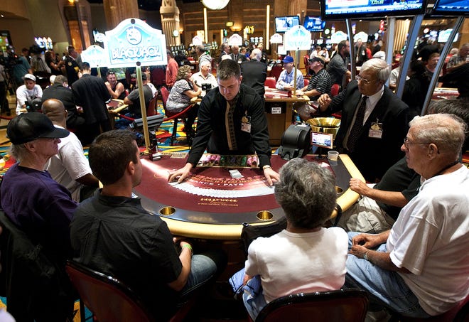 Patrons play blackjack during the first day of table games at Hollywood Casino at Penn National Race Course in East Hanover Township, Pa. Tuesday, July 13, 2010.