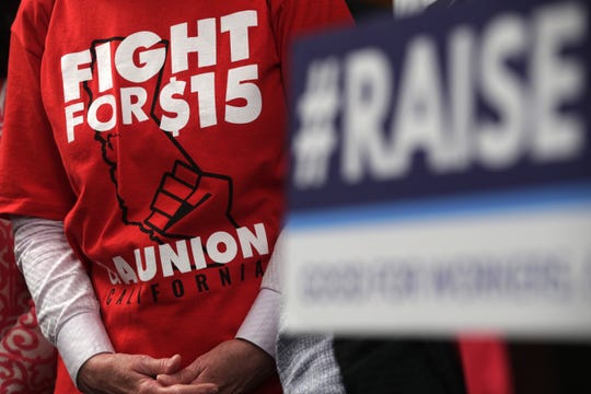 An activist wears a "Fight For $15" T-shirt during a news conference prior to a vote on the Raise the Wage Act July 18, 2019 at the U.S. Capitol in Washington, DC. The legislation would raise the federal minimum wage from $7.25 to $15 by 2025.
