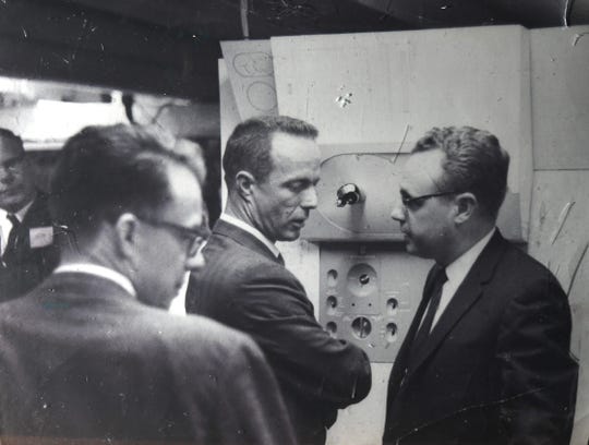 From left, engineer Harlan Neville, astronaut Alan Shepard and program director Jim Bevins are seen in the 1960s  with an analog computer simulation of a space sextant that would be used on the Apollo missions.