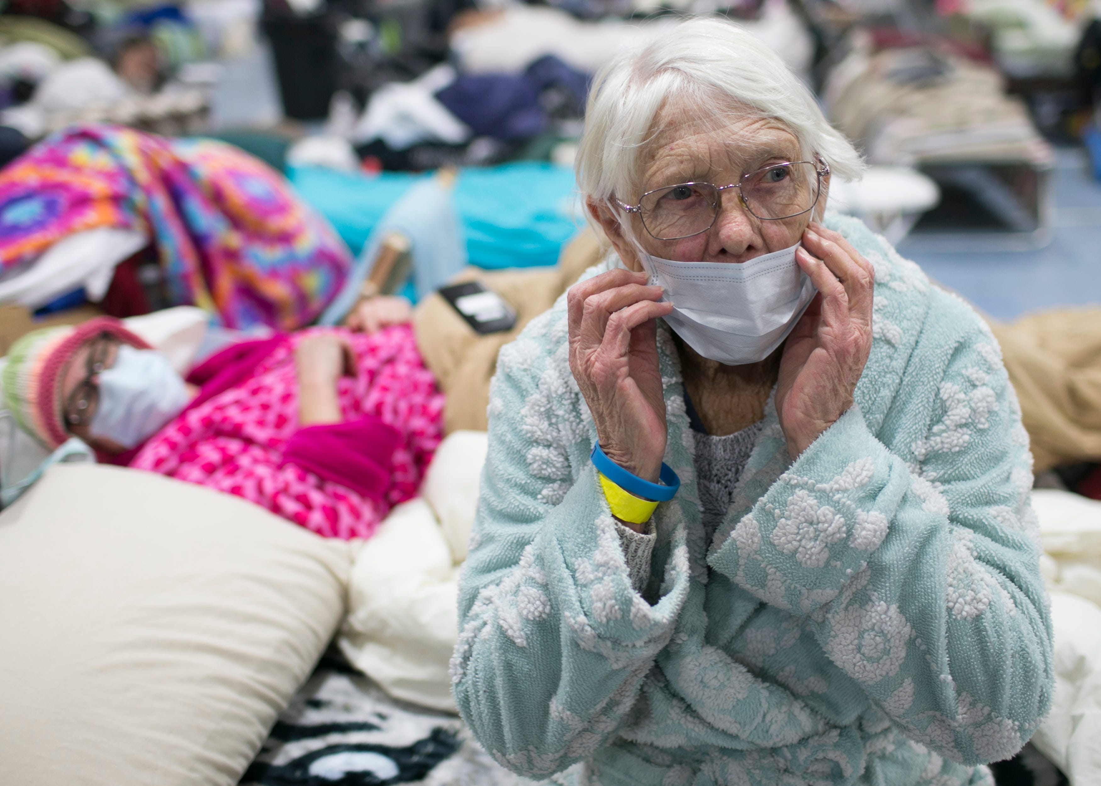 85-year-old Minna Andresen (right) sits for a portrait on a bed next to her daughter Libby Andresen (left) at the East Avenue Church Shelter in Chico, California on Thursday, November 15, 2018. The Andresens lost everything when the Camp Fire destroyed their property in Paradise.