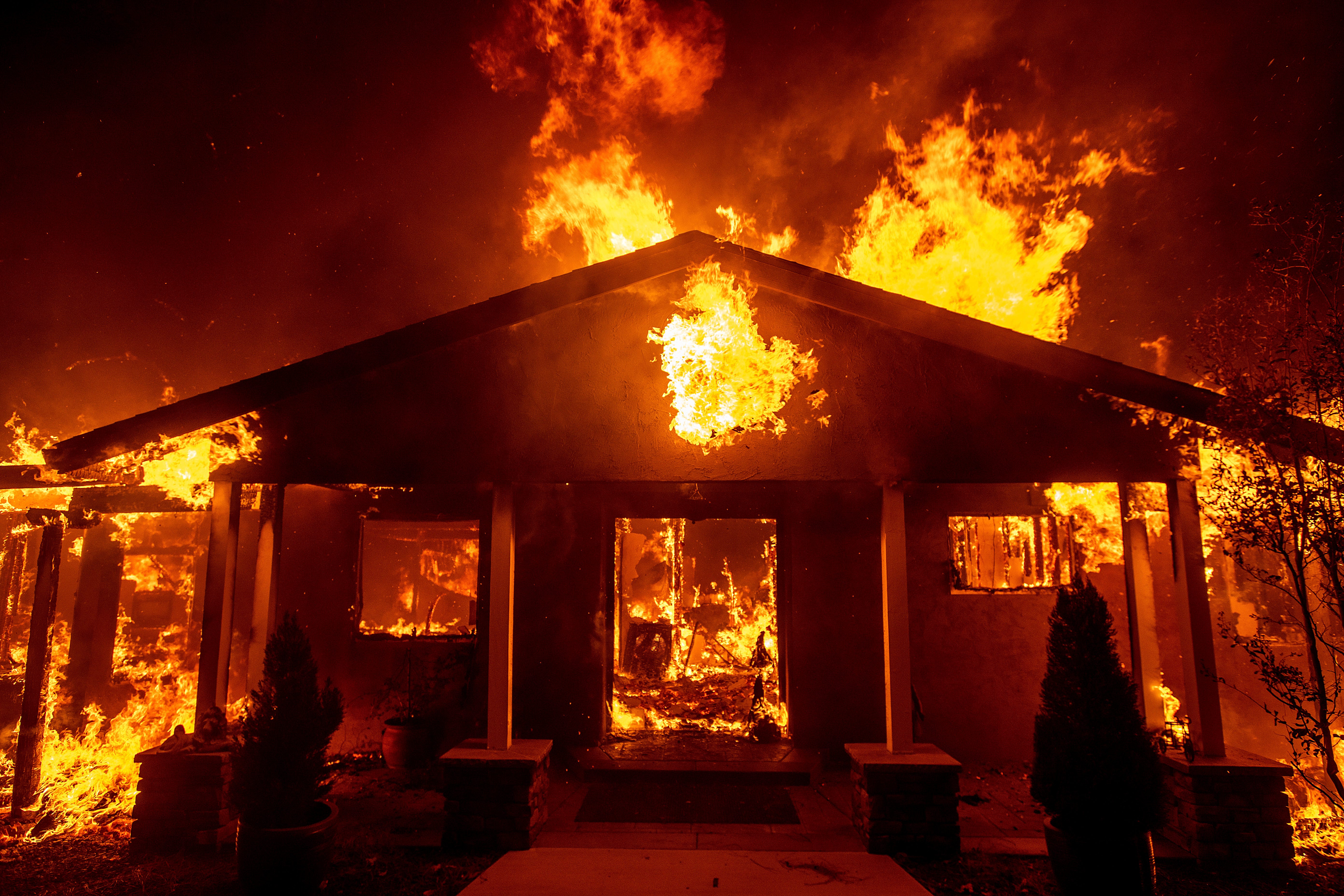 A home burns as the Camp Fire rages through Paradise, Calif., on Thursday, Nov. 8, 2018.