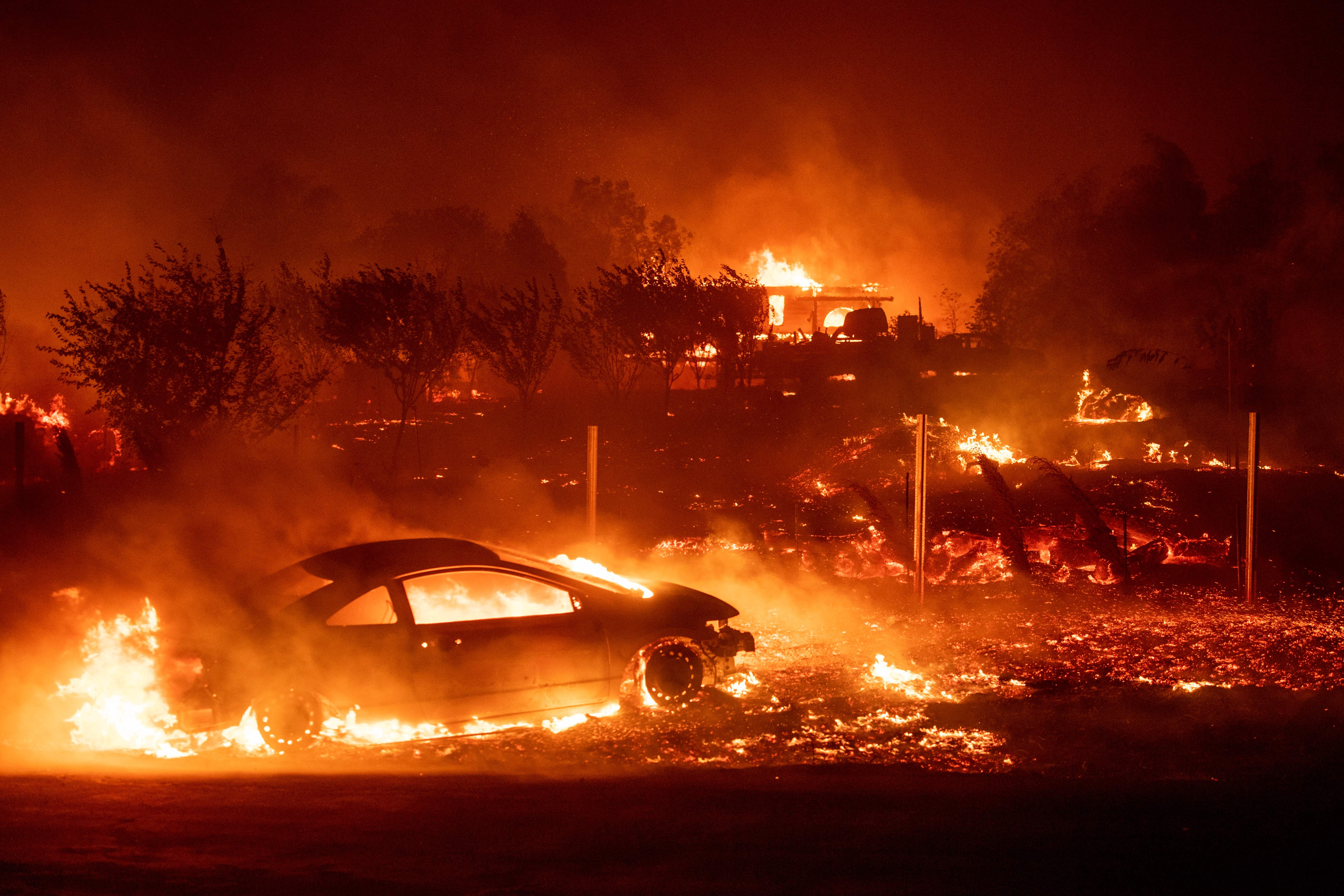 The Camp Fire consumes vehicles and homes as it rips through Paradise, California, on November 8, 2018.