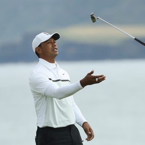 Tiger Woods tosses his club in the air on the 5th...
