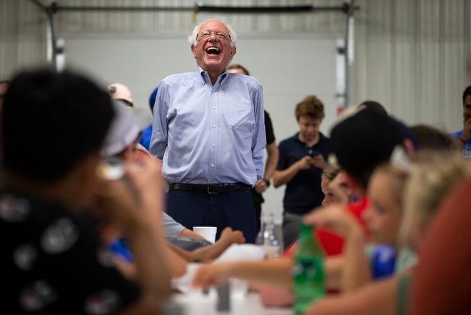 Democratic presidential candidate Bernie Sanders laughs at a response as he talks to kids at the Union County Democrats booth during the Union County Fair on July 20 in Afton.