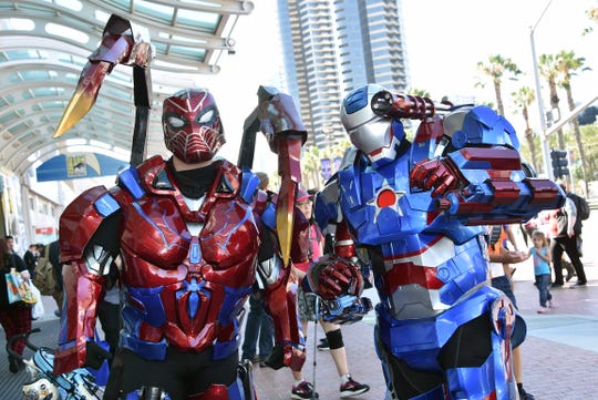 Cosplayers dressed as Transformers walk around San Diego during Comic-Con on July 19, 2019.