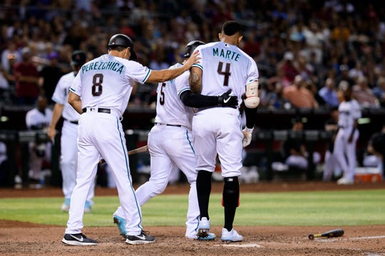 Ketel Marte #4 of the Arizona Diamondbacks is restrained by Eduardo Escobar #5 and third base coach Tony Perezchica #8 after striking out on a foul tip in the seventh inning of the MLB game against the Milwaukee Brewers at Chase Field on July 19, 2019 in Phoenix, Arizona. Ketel Marte was ejected from the game.