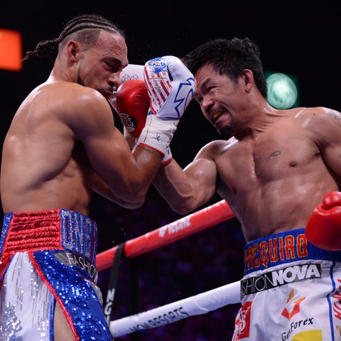 Manny Pacquiao lands a hit on Keith Thurman.