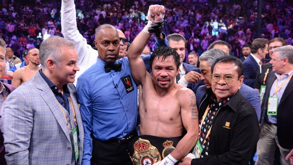 Manny Pacquiao celebrates after defeating Keith...
