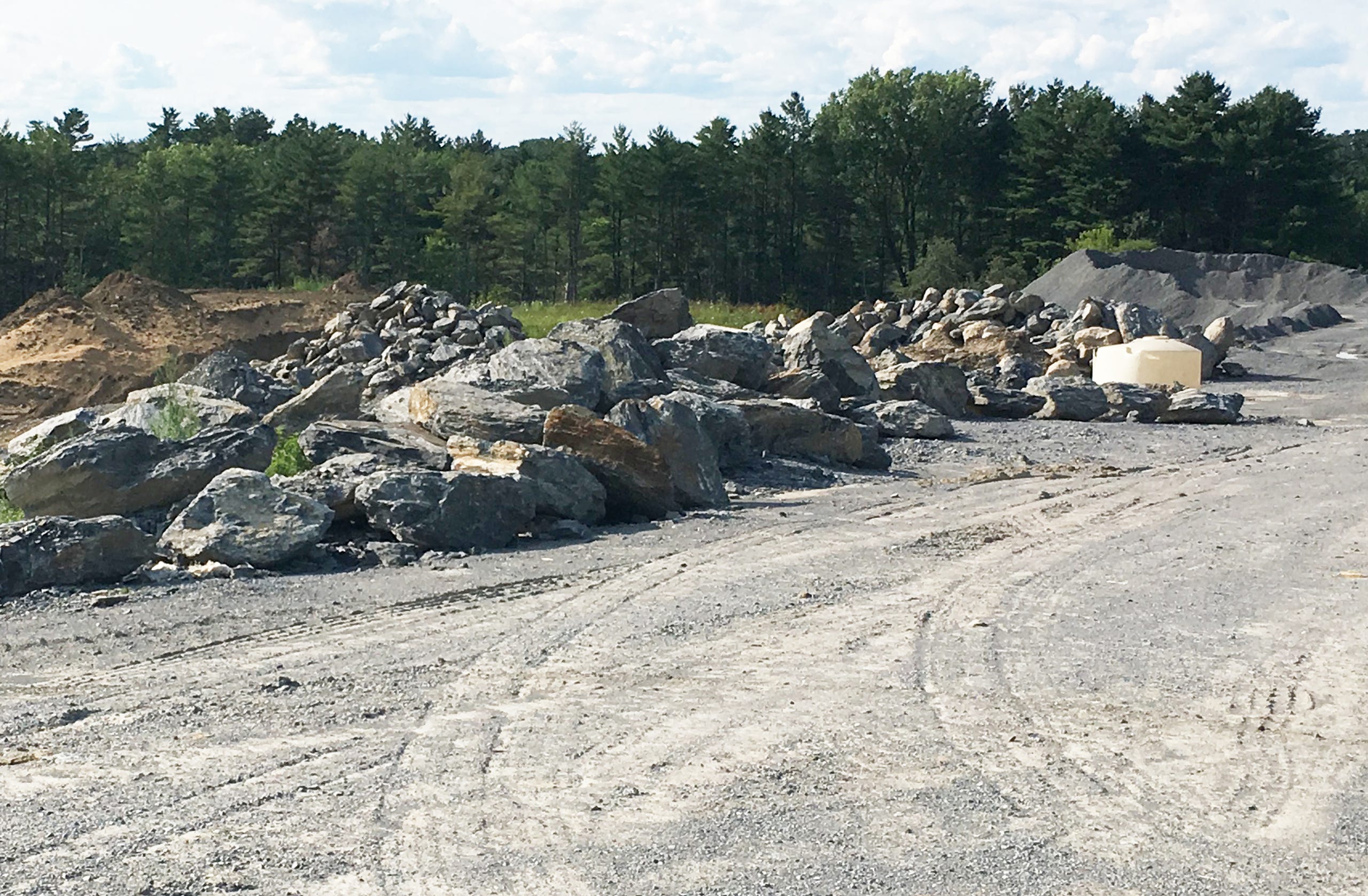 Boulders, gravel and topsoil are stockpiled at the edge of a housing development under construction at the O'Brien Farm in South Burlington on July 14, 2019.