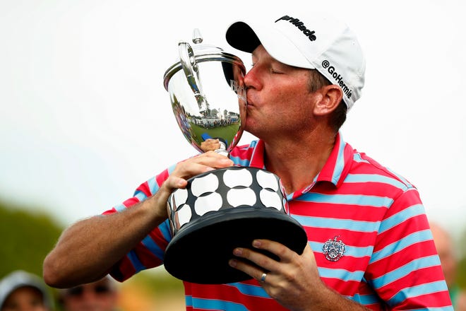 Jim Herman kisses the trophy after winning the PGA Barbasol Championship golf tournament at Keene Trace Golf Club's Champions Course in Nicholasville, Ky., Sunday, July 21, 2019. Herman, a Palm City resident, will compete at this weekend's Honda Classic in Palm Beach Gardens.