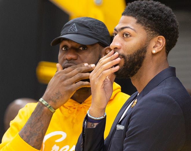 Los Angeles Lakers NBA basketball players, LeBron James, left, and Anthony Davis share a moment after Davis was introduced at a news conference at the UCLA Health Training Center in El Segundo, Calif., Saturday, July 13, 2019. (AP Photo/Damian Dovarganes)