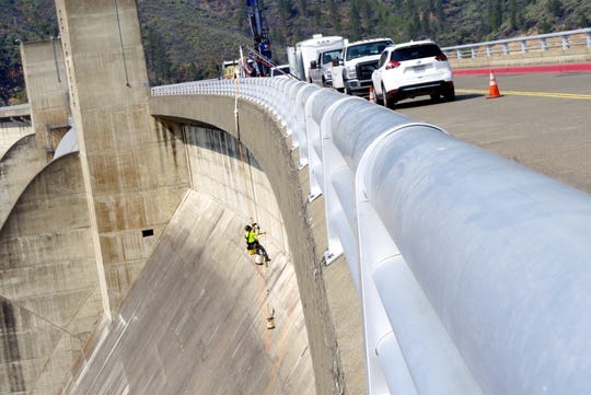 Workers did testing on Shasta Dam in 2018 to determine whether it could withstand having an additional 18 1/2 feet of concrete placed on the crest of the dam.