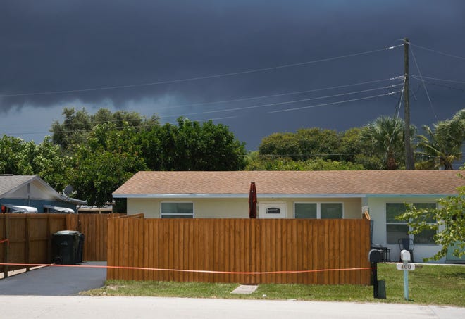 The 6-foot fence at 402 Fini Drive in Stuart has led to city officials questioning whether to lower the height limit on fences.