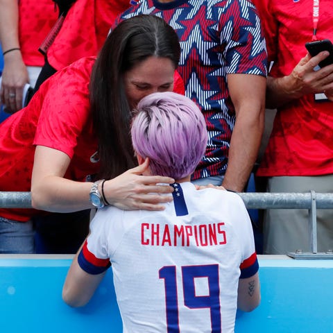 United States forward Megan Rapinoe kisses...