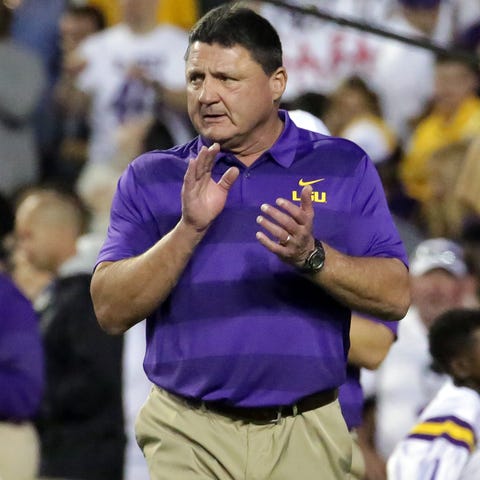 Ed Orgeron cheers on his players during warm-up...