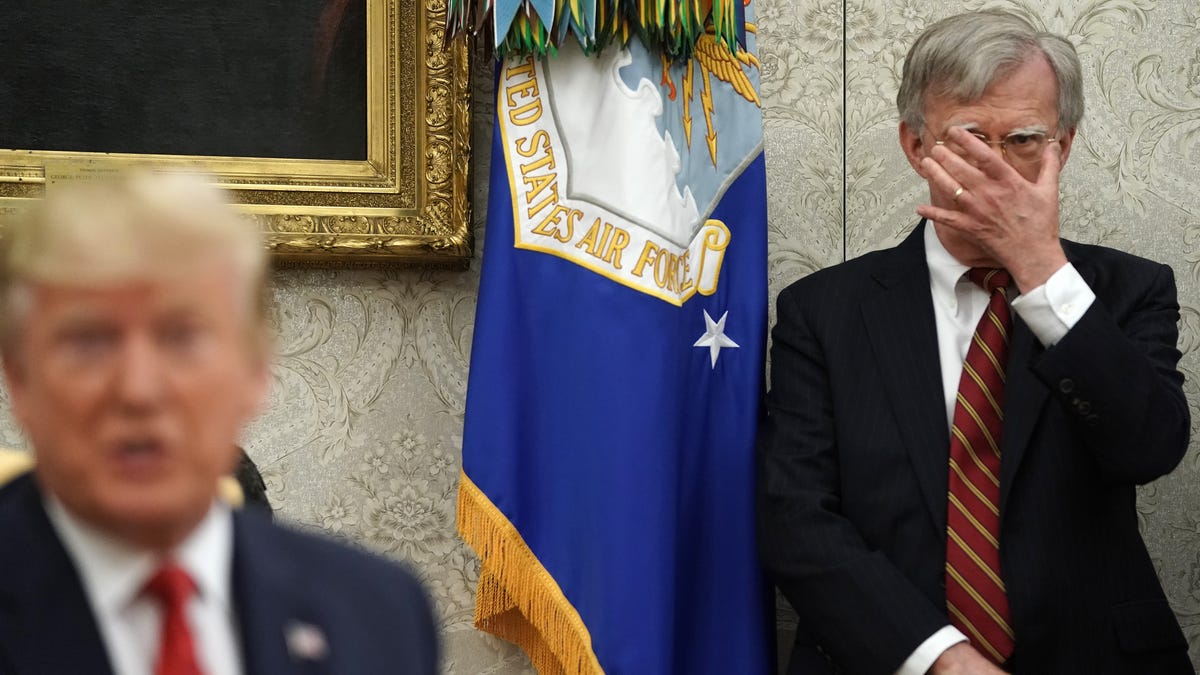 White House National Security Advisor John Bolton, right, listens to President Donald Trump in the Oval Office at the White House on July 18, 2019.