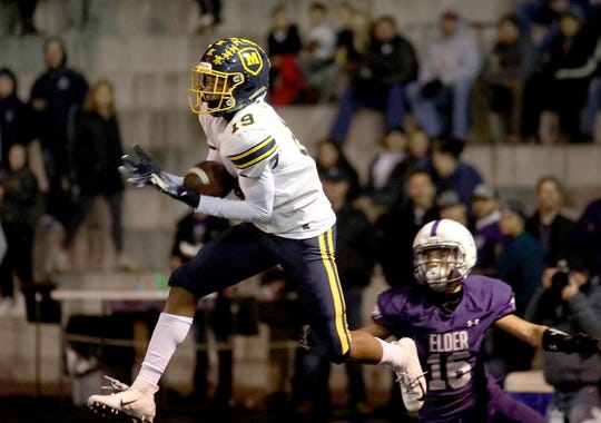 Moeller defensive back Carrington Valentine intercepts a pass during the Crusaders' playoff game against Elder, Friday, Nov. 2, 2018.