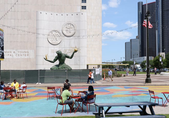 A few people enjoy Spirit Plaza in downtown Detroit on Tuesday, July 23, 2019.