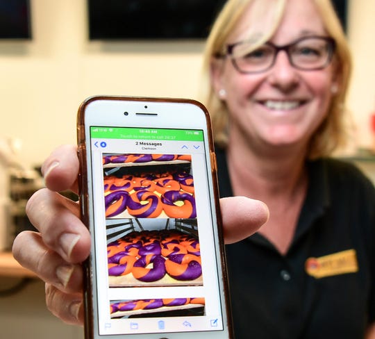 Owner Marmie Kreps shows the NYC Bagel shop's National Championship bagel, one of many types of food items as she prepares for an August 31 opening at 125 U.S. 76 at the Granmarc complex in Clemson. 