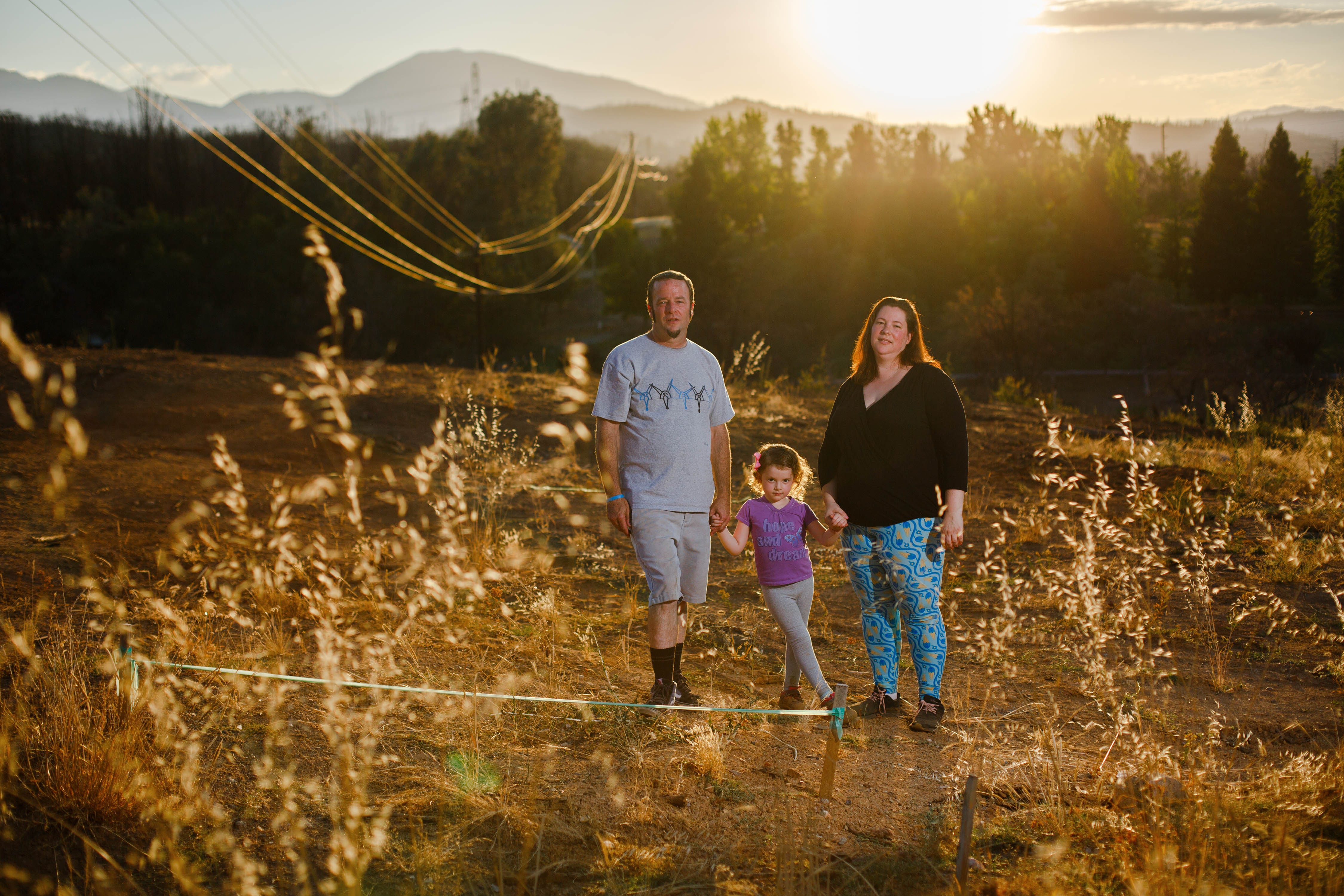 The Bush family is pictured in the empty lot where their house once stood. The Bush family lost their home after the Carr Fire swept through Redding and are now in the process of rebuilding.