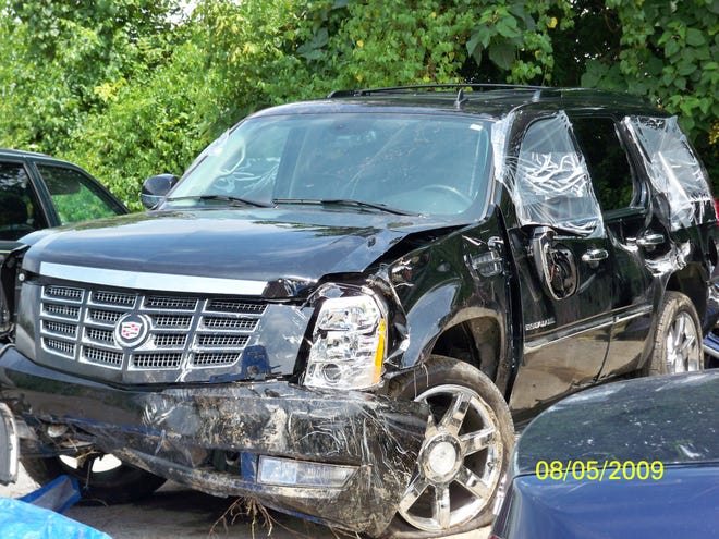 A photograph of Shannon Hercutt's 2007 Cadillac Escalade shows damage incurred when it plunged down a 125-foot embankment in Sevier County on August 3, 2009.