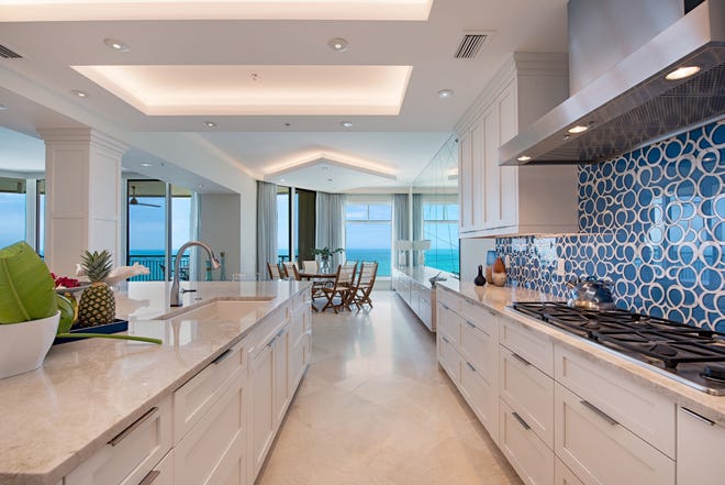 An oversized island with a quartzite countertop is one of the many features of the renovated kitchen.