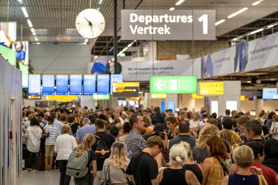  People waiting in the departure hall of the airport Amsterdam-Schiphol, southwest of Amsterdam, as a problem with refueling grounded several dozen planes and hundreds of passengers July 24, 2019. 