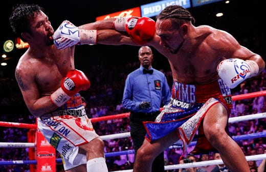 Manny Pacquiao of the Philippines (L) in action against Keith Thurman of the US for their WBA Super Welterweight World Championship title fight at MGM Grand Garden Arena in Las Vegas, Nevada, July 20, 2019.