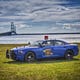 A Michigan State Police car in front of the Mackinac Bridge.